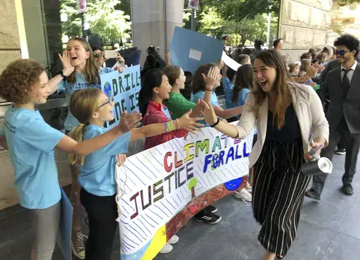 Kelsey Juliana, of Eugene, Ore., a lead plaintiff who is part of a lawsuit by a group of young people who say U.S. energy policies are causing climate change and hurting their future, greets supporters outside a federal courthouse, June 4, 2019, in Portland, Ore. A 9th U.S. Circuit Court of Appeals panel on Wednesday, May 1, 2024, rejected a long-running lawsuit brought by young Oregon-based climate activists who argued that the U.S. government's role in climate change violated their constitutio