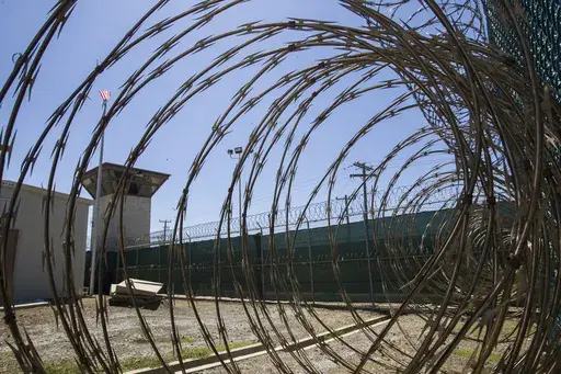 In this April 17, 2019, photo, reviewed by U.S. military officials, the control tower is seen through the razor wire inside the Camp VI detention facility in Guantanamo Bay Naval Base, Cuba. A military medical panel has concluded that one of the five 9/11 defendants held at Guantanamo Bay has been rendered delusional and psychotic by the torture he underwent years ago while in CIA custody. A military judge is expected to rule as soon as Thursday whether al-Shibh’s mental issues render him inco