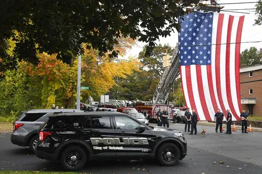 Police officers from Bristol, Conn. gather with other towns at the scene where two police officers killed, Thursday, Oct. 13, 2022, in Bristol, Conn. The deaths of two Connecticut police officers and the wounding of a third during an especially violent week for police across the U.S. fit into a grim pattern, law enforcement experts say. Even as the number of officers has dropped in the past two years, the number being targeted and killed has risen. (AP Photo/Jessica Hill, File)