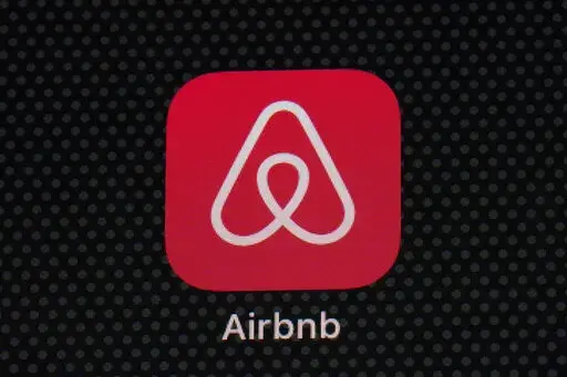 The Airbnb app icon is displayed on an iPad screen in Washington, D.C., on May 8, 2021.  NerdWallet looked at the price of 1,000 Airbnb listings and compared them to the cost of hotels. Airbnbs can be an affordable alternative to hotels, particularly for longer stays, large groups and for people who need a washer and dryer or kitchen. But beware of vacation rental cleaning fees that can make the price skyrocket, and take advantage of discounts for monthlong stays.  (AP Photo/Patrick Semansky, Fi