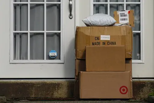 Packages are seen stacked on the doorstep of a residence, Wednesday, Oct. 27, 2021, in Upper Darby, Pa. (AP Photo/Matt Slocum, File)
