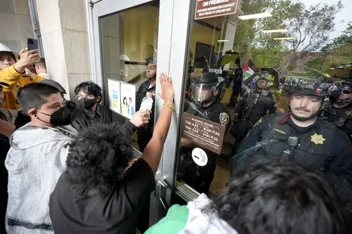 Police block pro-Palestinian demonstrators from entering a building on the UCLA campus, May 23, 2024, in Los Angeles. (AP Photo/Ryan Sun, File)