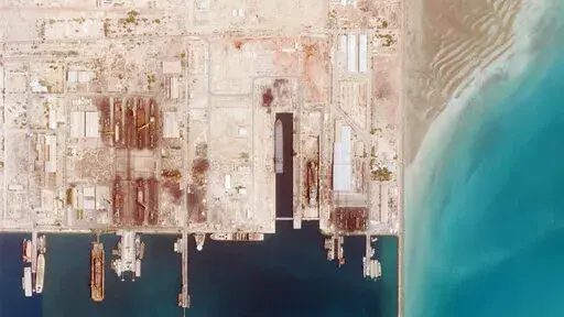 This satellite photo from Planet Labs PBC shows the Iranian Revolutionary Guard's newest ship, the Shahid Mahdavi, center right, under construction in a shipyard west of Bandar Abbas, Iran, Saturday, May 21, 2022. Iran's paramilitary Revolutionary Guard is building the massive new support ship near the strategic Strait of Hormuz as it tries to expand its naval presence in waters vital to international energy supplies and beyond, satellite photos obtained by The Associated Press show. (Planet Lab