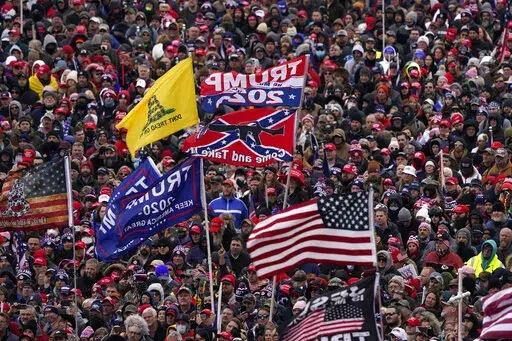 People listen as President Donald Trump speaks during a rally Jan. 6, 2021, in Washington. (AP Photo/Evan Vucci, File)