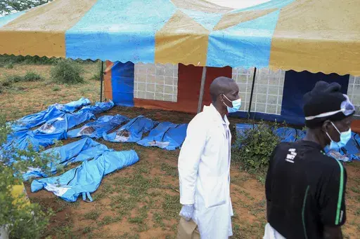 The exhumed bodies of victims of a religious cult are laid out in the village of Shakahola, near the coastal city of Malindi, in southern Kenya Sunday, April 23, 2023. Dozens of bodies have been discovered so far in shallow graves on land owned by a pastor Paul Makenzi in coastal Kenya who was arrested for telling his followers to fast to death. (AP Photo)