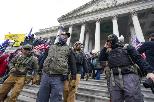 Members of the Oath Keepers on the East Front of the U.S. Capitol on Jan. 6, 2021, in Washington. A member of the Oath Keepers who traveled to Washington before the Jan. 6 attack at the U.S. Capitol testified during the seditious conspiracy case against Oath Keepers founder Stewart Rhodes and four associates on Wednesday, Oct. 12, 2022, about a massive cache of weapons the far-right extremist group stashed in a Virginia hotel room. (AP Photo/Manuel Balce Ceneta)