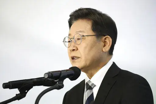 Lee Jae-myung, a candidate of the ruling Democratic Party for next March's presidential election, speaks during a New Year press conference at a Kia Motors' plant in Gyeonggi-do, South Korea Tuesday, Jan. 4, 2022.  (Chung Sung-Jun/Pool Photo via AP)