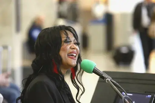 Roz McCommen sings at Seattle-Tacoma International Airport on November 26, 2024, in SeaTac, Wash. (AP Photo/Manual Valdes)