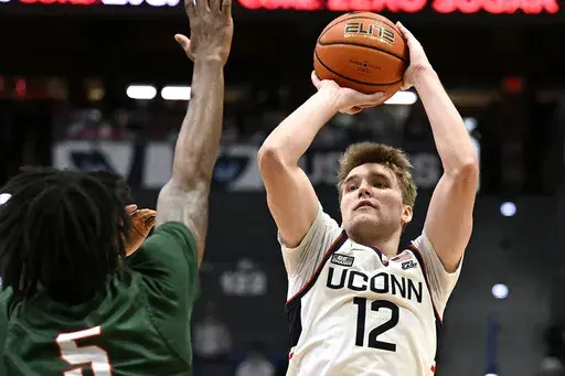 UConn guard Cam Spencer (12) shoots over Mississippi Valley State forward Walter Hamilton in the second half of an NCAA college basketball game, Tuesday, Nov. 14, 2023, in Hartford, Conn. (AP Photo/Jessica Hill)