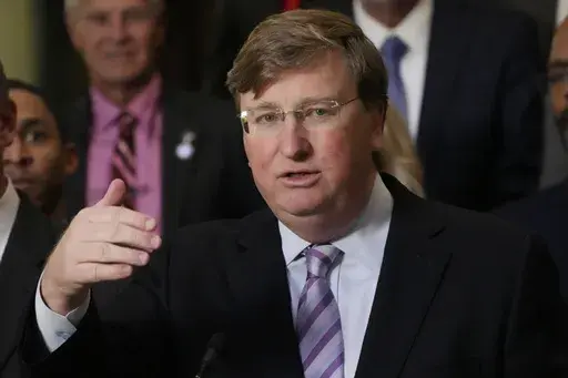 Mississippi Republican Gov. Tate Reeves responds to a reporter's question regarding the passage of a package of state incentives to support a plan by Amazon Web Services to build two data centers in the central part of the state, Thursday, Jan. 25, 2024, at the Capitol in Jackson, Miss. (AP Photo/Rogelio V. Solis)