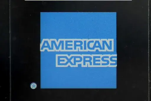 An American Express logo is attached to a door in Boston's Seaport District, July 21, 2021. American Express announced Friday, June 21, 2024, it will acquire the dining reservation and event management platform Tock from Squarespace for $400 million cash. (AP Photo/Steven Senne, File)