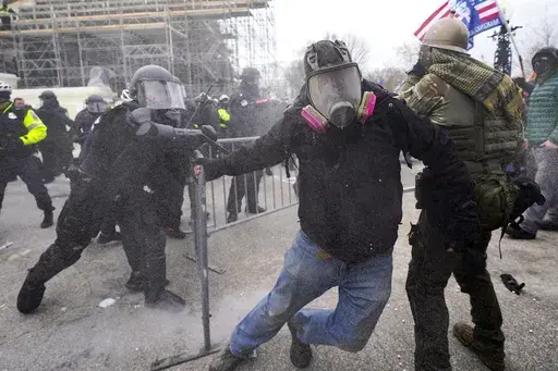 Insurrectionists loyal to President Donald Trump confront police as they storm the U.S. Capitol on Jan. 6, 2021, in Washington. Former President Donald Trump said during a debate with President Joe Biden last week that the Jan. 6, 2021, attack on the Capitol involved a "relatively small" group of people who were "in many cases ushered in by the police." (AP Photo/Julio Cortez, File)