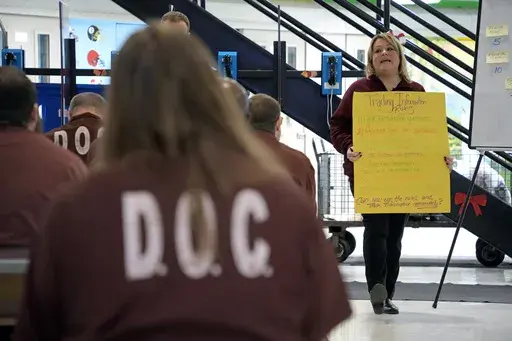 Prison psychological specialist Christine Ransom, right, leads a group session for inmates, Dec. 14, 2023, in the Neurodevelopmental Residential Treatment Unit at Pennsylvania's State Correctional Institution in Albion, Pa. The prison unit is helping men with autism and their intellectual and developmental disabilities stay safe behind bars while learning life skills. The unit is the first in the state and one of only a handful nationwide. (AP Photo/Gene J. Puskar)