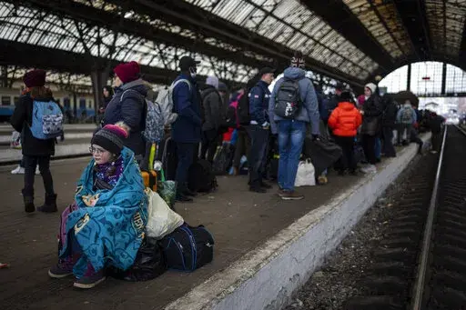 Passengers wait at the platform inside Lviv railway station, Sunday, Feb. 27, 2022, in Lviv, west Ukraine. (AP Photo/Bernat Armangue)
