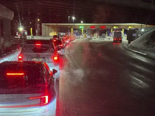 Cars are backed up at the US-Canada border in Stanstead, Quebec, after a shooting involving a U.S. Border Patrol agent in Coventry, Vt., Monday, Jan. 20, 2025. (AP Photo/Chloe Jones)