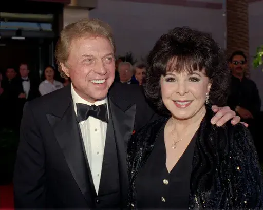 Singer Steve Lawrence, left, and his wife Eydie Gorme arrive at a black-tie gala called honoring Frank Sinatra in Las Vegas on May 30, 1998. Lawrence, a singer and top stage act who as a solo performer and in tandem with his wife Gorme kept Tin Pan Alley alive during the rock era, died Wednesday, March 6, 2024 at age 88. Gorme died on Aug. 10, 2013. (AP Photo/Lennox McLendon, File)