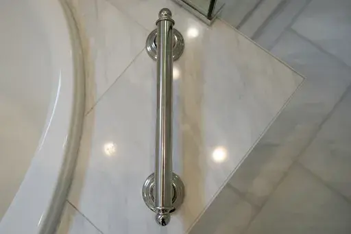 A grab bar next to the bathtub is shown in the recently remodeled home of Gene and Sallie Carr on Tuesday, May 7, 2024, in Hendersonville, N.C. An increasing number of Americans in their late 50s and older are staying in their houses, some by choice, others because they're locked into low mortgage rates that are too low to give up. (AP Photo/Chris Carlson)