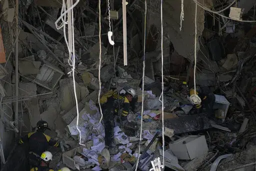 Rescuers search for survivors at the site of Friday's deadly explosion that destroyed the five-star Hotel Saratoga, in Havana, Cuba, Saturday, May 7, 2022. (AP Photo/Ramon Espinosa)
