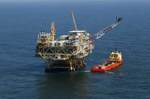 A rig and supply vessel in the Gulf of Mexico, off the cost of Louisiana, are seen Sunday, April 10, 2011. On Monday, Sept. 12, 2022, the U.S. Department of the Interior said that it wants to reverse some Trump administration rollbacks of offshore safety rules to prevent blowouts like the BP catastrophe that killed 11 people and fouled the Gulf of Mexico in 2010. (AP Photo/Gerald Herbert, File)