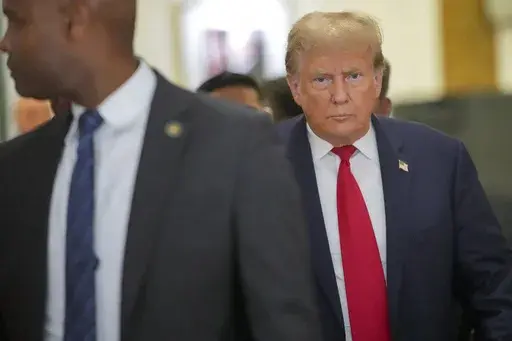Former President Donald Trump leaves the courtroom during a lunch break in his civil business fraud trial, Wednesday, Oct. 4, 2023, in New York. (AP Photo/Mary Altaffer)