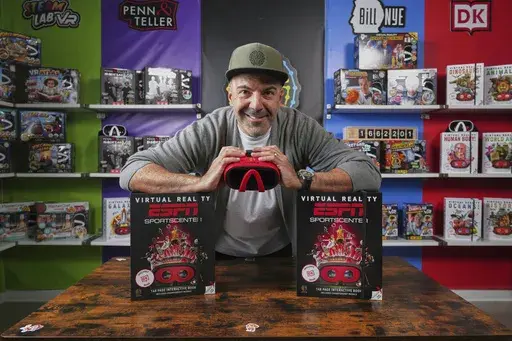 Steve Rad, CEO of toy maker Abacus Brands Inc., which designs science kits and other educational toys for older children, shows a new improved matte box, left, that will replace its black mold plastic material packaging insert with an improved cardboard material to help offset the costs of future tariffs in El Segundo, Calif., on Monday, March 31, 2025. (AP Photo/Damian Dovarganes)