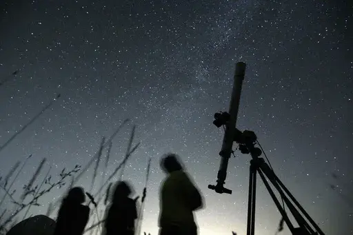 People look up to the sky at an observatory near the village of Avren east of the Bulgarian capital Sofia, Wednesday, Aug. 12, 2009. There's another chance to see five planets lined up in the sky, weather permitting. Saturn, Neptune, Jupiter, Uranus and Mercury will appear together before sunrise on Saturday., June 17, 2023. Jupiter and Saturn will be bright in the sky and easiest to see. Mercury will be the lowest to the horizon and harder to spot. And you'll need to break out binoculars or a t