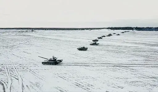 In this photo taken from video and released by the Russian Defense Ministry Press Service on Friday, Feb. 4, 2022, tanks and armored vehicles move during the Belarusian and Russian joint military drills at Brestsky firing range, Belarus. With Russia carrying out a massive military buildup near Ukraine and the West roundly rejecting Moscow’s security demands, a window for diplomacy in the crisis appears to be closing. But even as Moscow continues to bolster its forces and holds sweeping war gam
