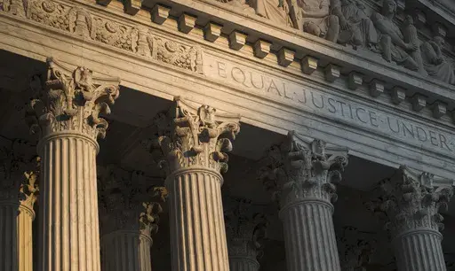 The Supreme Court in Washington is seen at sunset on Oct. 10, 2017. In a monthslong inquiry, which included reviewing tens of thousands of pages of documents from more than 100 public records requests, The Associated Press has examined what happens behind the scenes when Supreme Court justices travel to colleges and universities for lectures and other events. The AP learned the identities of donors and politicians invited to events with justices, details about the perks that have accompanied the