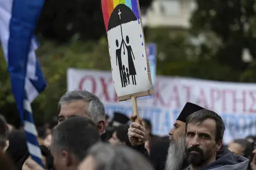 A protester raises a banner during a rally against same-sex marriage, at central Syntagma square, in Athens, Greece, Sunday, Feb. 11, 2024. Greece is becoming the first majority-Orthodox Christian nation to legalize same-sex marriage. At least for the near future, it will be the only one. The Eastern Orthodox leadership, despite lacking a single doctrinal authority like a pope, has been unanimous in opposing recognition of same-sex relationships. (AP Photo/Yorgos Karahalis, File)