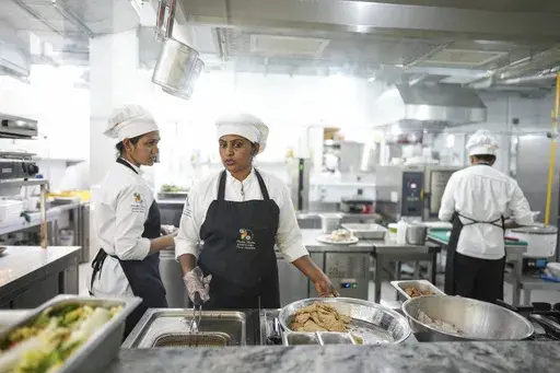 Cook Malithi Prabhani, second left, and her colleagues prepare lunch for guests at the Amba Yaalu resort in the Kandalama locality in Dambulla, Sri Lanka, Friday, Feb. 21, 2025. (AP Photo/Eranga Jayawardena)