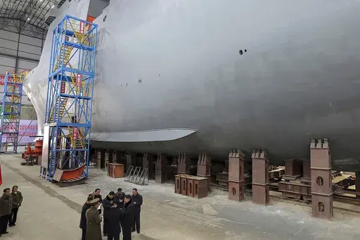In this undated photo provided on March 8, 2025, by the North Korean government, North Korean leader Kim Jong Un, bottom right, visits a shipyard to construct warships at an undisclosed place in North Korea. Independent journalists were not given access to cover the event depicted in this image distributed by the North Korean government. The content of this image is as provided and cannot be independently verified. (Korean Central News Agency/Korea News Service via AP)