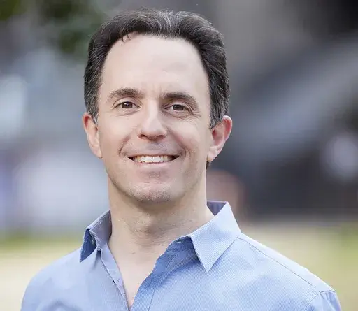 In this undated photo provided by Rebecca Hale, Marc Tyler Nobleman poses for a portrait. The author's clash with a Georgia school district over a mention of someone's homosexuality in a presentation highlights the reach of conservatives' push for what what they call parents' rights. Nobleman at first complied with a request not to mention that the son of Batman's co-creator was gay but then rebelled. He and LGBTQ+ advocates say the Forsyth County district in suburban Atlanta was wrong. The dist