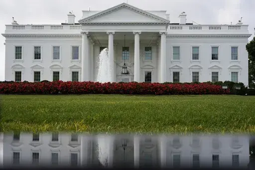 The White House is seen reflected in a puddle, Saturday, Sept. 3, 2022, in Washington. With roughly a year and a half until the 2024 presidential contest, the field of candidates is largely set. Former President Donald Trump and Florida Gov. Ron DeSantis have dominated the early Republican race, but other candidates including former Vice President Mike Pence, former United Nations Ambassador Nikki Haley and U.S. Sen. Tim Scott of South Carolina are looking for an opening in case either falters. 