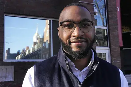 Quentin Fulks, who managed Sen. Raphael Warnock's re-election campaign in 2022, stands for a portrait outside the John F. Kennedy School of Government at Harvard University, Feb. 2, 2023, in Cambridge, Mass. Fulks, former top campaign aide for U.S. Sen. Raphael Warnock, has been named principal deputy campaign manager for President Joe Biden's 2024 reelection bid. (AP Photo/Charles Krupa, file)