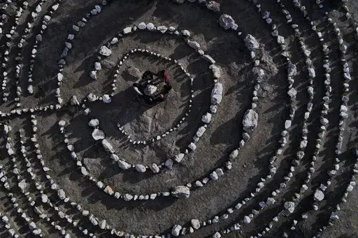A group of Brazilian tourists hold hands standing in a circle at the heart of a stone labyrinth in the Pueblo Encanto spiritual theme park in Capilla del Monte, Argentina, Wednesday, July 19, 2023. In the pope’s homeland of Argentina, Catholics have been renouncing the faith and joining the growing ranks of the religiously unaffiliated. Commonly known as the “nones,” they describe themselves as atheists, agnostics, spiritual but not religious, or simply: “nothing in particular.” (AP Ph