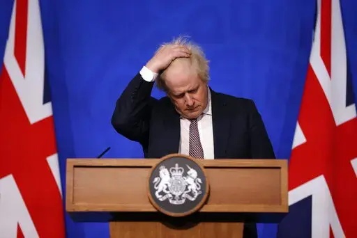 Britain's Prime Minister Boris Johnson gestures as he speaks during a press conference in London, Saturday Nov. 27, 2021, after cases of the new COVID-19 variant were confirmed in the UK. (Hollie Adams/Pool via AP)