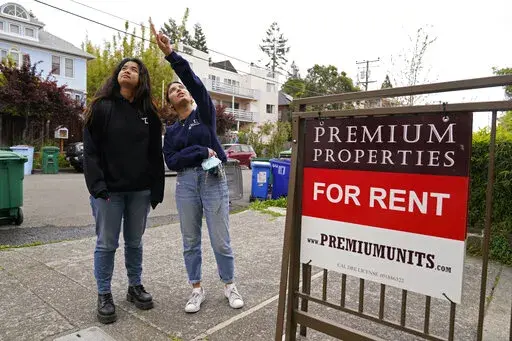 University of California, Berkeley freshmen Sanaa Sodhi, right, and Cheryl Tugade look for apartments in Berkeley, Calif., Tuesday, March 29, 2022. Millions of college students in the U.S. are trying to find an affordable place to live as rents surge nationally, affecting seniors, young families and students alike. Sodhi is looking for an apartment to rent with three friends next fall, away from the dorms but still close to classes and activities on campus. They've budgeted at least $5,200 for a