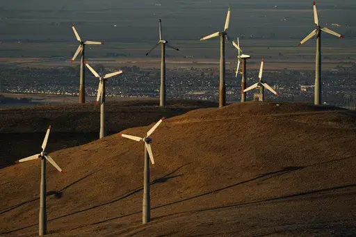 Wind turbines operate in Livermore, Calif., on Wednesday, Aug. 10, 2022. Across Europe companies are weighing up the U.S. Inflation Reduction Act's $375 billion in benefits for renewable industries against the European Union's fragmented response. (AP Photo/Godofredo A. Vásquez, File)