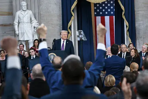 Attendees cheer as President Donald Trump speaks after taking the oath of office during the 60th Presidential Inauguration in the Rotunda of the U.S. Capitol in Washington, Monday, Jan. 20, 2025. (Kenny Holston/The New York Times via AP, Pool)