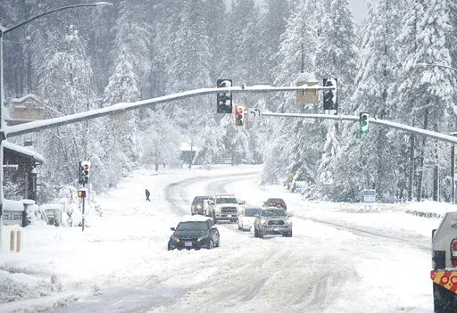 A vehicle is stuck in the snow along Brunswick Road and Sutton Way Monday morning, Dec. 27, 2021, in Grass Valley, Calif. (Elias Funez/The Union via AP)