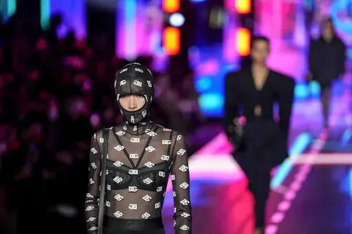 A model wears a creation as part of the Dolce & Gabbana Fall/Winter 2022-2023 fashion collection, unveiled during the Fashion Week in Milan, Italy, Saturday, Feb. 26, 2022. (AP Photo/Antonio Calanni)