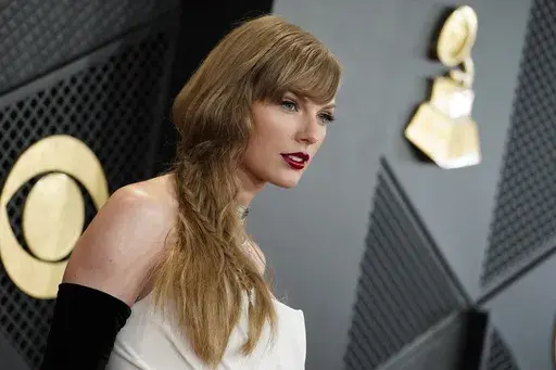 Taylor Swift arrives at the 66th annual Grammy Awards on Feb. 4, 2024, in Los Angeles. A photographer told police he was punched in the face by Taylor Swift’s father on the Sydney waterfront on Tuesday, Feb. 27, 2024, hours after the pop star’s Australian tour ended. (Photo by Jordan Strauss/Invision/AP, File)
