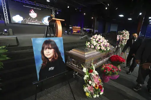 The casket containing 14-year-old Valentina Orellana-Peralta, killed on Dec. 23, 2021 by a LAPD police officer's stray bullet while shopping with her mother, is readied for her funeral at the City of Refuge Church in Gardena, Calif., Monday, Jan. 10, 2022. (AP Photo/David Swanson)