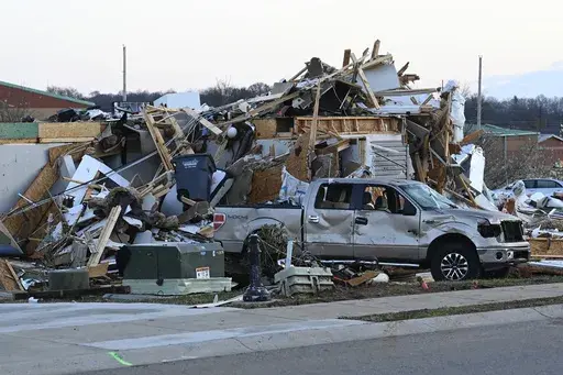 A damaged car sits by homes destroyed from severe weather in the West Creek Farms neighborhood on Sunday, Dec. 10, 2023, Clarksville, Tenn. If your home was hit by high water or a fire emergency, would your important papers be safe? Items like insurance information, birth and marriage certificates, passports, Social Security cards and estate planning paperwork should all be protected in case the worst happens. (AP Photo/Mark Zaleski, File)