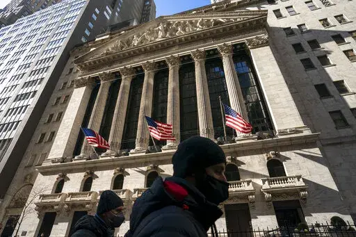 A pedestrian passes the New York Stock Exchange, Monday, Jan. 24, 2022, in New York. Stocks have fallen sharply so far this year as the market readies for the Federal Reserve to raise interest rates to try to tame inflation, which is at its highest level in nearly four decades. (AP Photo/John Minchillo)