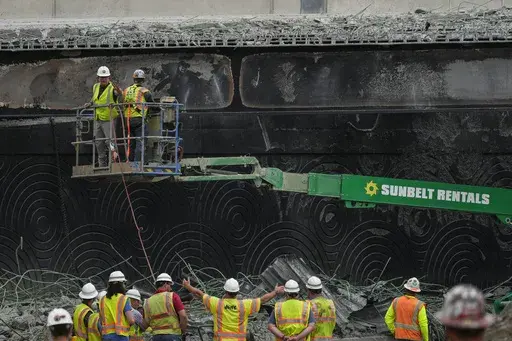 Crews continue to work the scene of a collapsed elevated section of Interstate 95, in Philadelphia, Wednesday, June 14, 2023. (AP Photo/Matt Rourke)