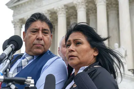 Beatriz Gonzalez, right, the mother of 23-year-old Nohemi Gonzalez, a student killed in the Paris terrorist attacks, and stepfather Jose Hernandez, speak outside the Supreme Court,Tuesday, Feb. 21, 2023, in Washington. A lawsuit against YouTube from the family of Nohemi Gonzalez was argued at the Supreme Court. (AP Photo/Alex Brandon)