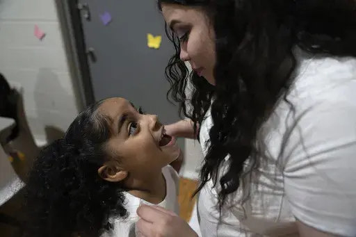 Myla Martinez, 6-year-old, enthusiastically greets her mother Crystal Martinez as she and her four younger siblings spend time her with her during a special visit at Logan Correctional Center, Saturday, May 20, 2023, in Lincoln, Illinois. Rare programs like the Reunification Ride, a donation-dependent initiative that buses prisoners' family members from Chicago to Illinois' largest women's prison every month so they can spend time with their mothers and grandmothers, are a crucial lifeline for f