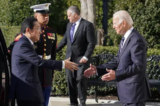 President Joe Biden greets Japanese Prime Minister Fumio Kishida on the South Lawn of the White House, Friday, Jan. 13, 2023, in Washington. (AP Photo/Evan Vucci)