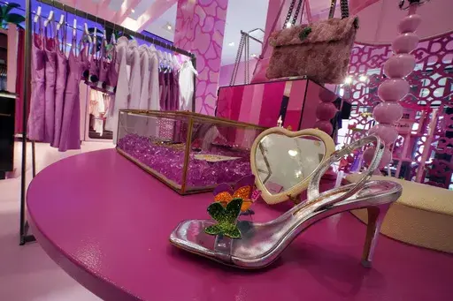 Barbie-themed merchandise is displayed in a special section at Bloomingdale's, in New York, Thursday, July 20, 2023. According to the fashion company LYST, the "Barbiecore" trend began after pictures of a pink-clad Margot Robbie surfaced online in June 2022, a year before the actor's "Barbie" movie came out and toy maker Mattel launched its own marketing blitz to promote the color. (AP Photo/Richard Drew, File)